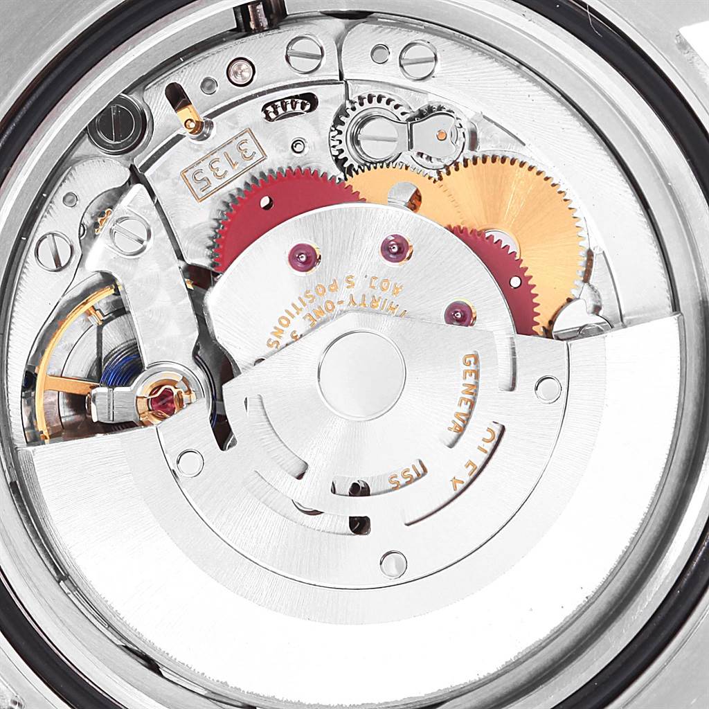 The image shows a close-up of the Rolex Submariner 116613 Men's Steel and Gold (two tone) Blue Dial 116613 Men's Steel and Gold (two tone) Blue Dial's movement, detailing gears, jewels, and other internal components.