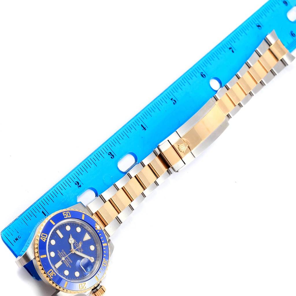 This image shows a Rolex Submariner 116613 Men's Steel and Gold (two tone) Blue Dial 116613 Men's Steel and Gold (two tone) Blue Dial watch, focusing on the dial and band, measured alongside a blue ruler.