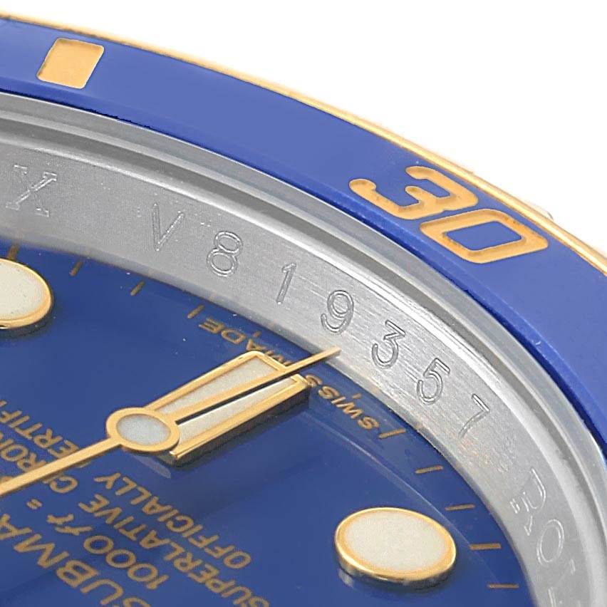 This close-up image shows the bezel, dial, and hands of the Rolex Submariner 116613 Men's Steel and Gold (two tone) Blue Dial 116613 Men's Steel and Gold (two tone) Blue Dial watch.