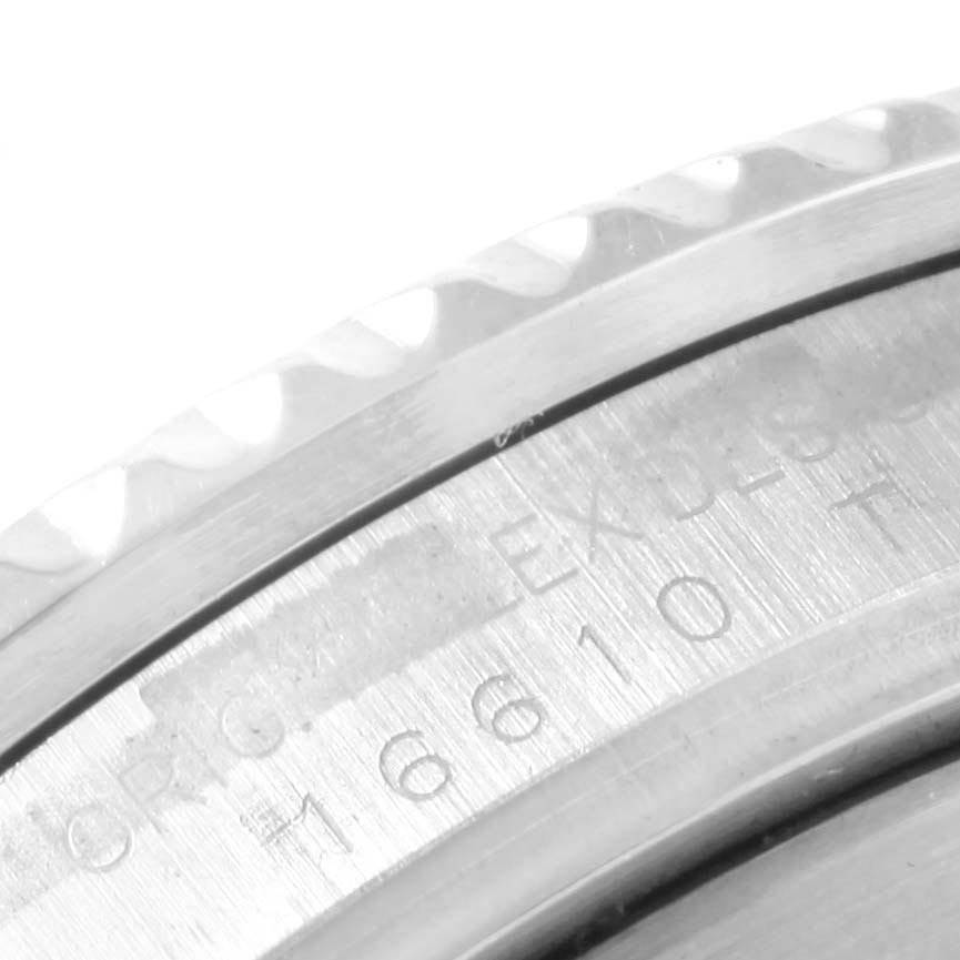 The image shows a close-up of the engraved case back and partially the bezel of the Rolex Submariner 16610 Men's Stainless Steel Black Dial 16610 Men's Stainless Steel Black Dial.