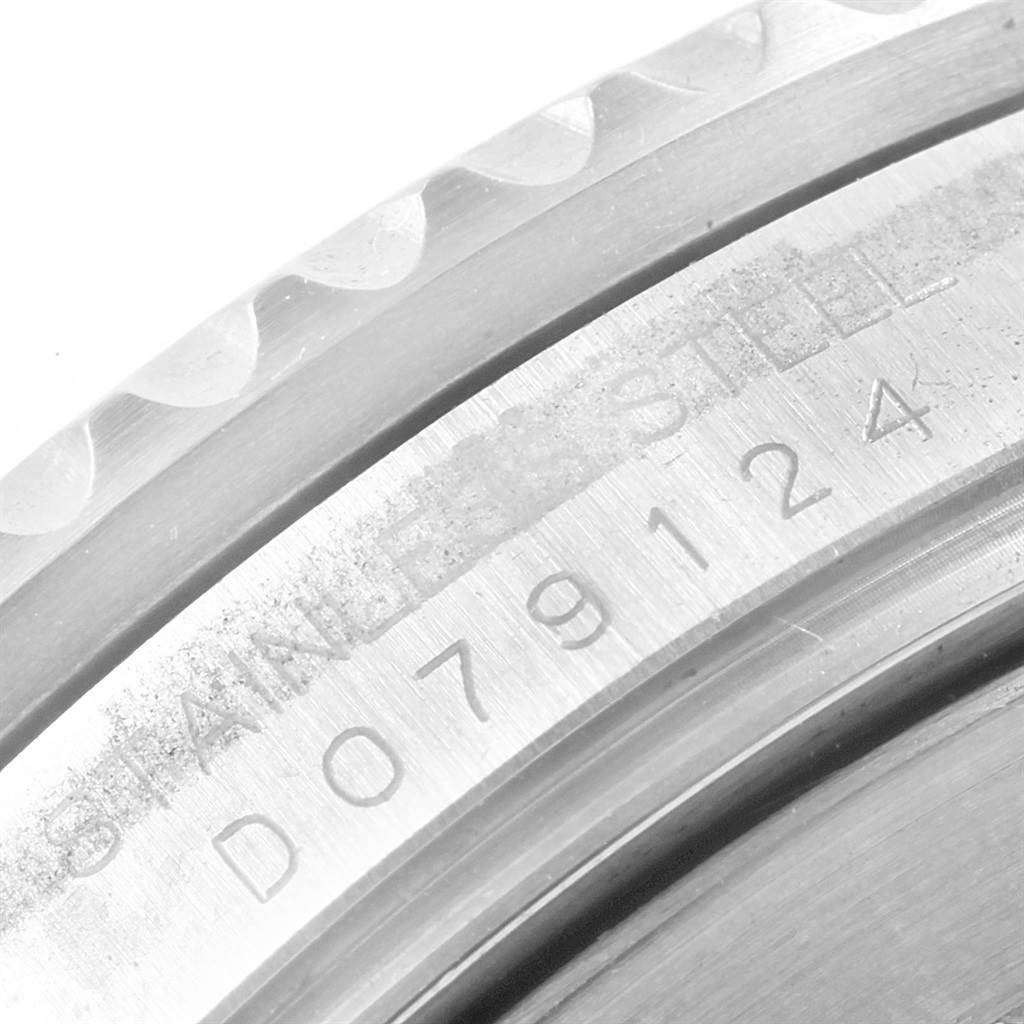This image shows a close-up angle of the outer edge and serial number's engraving on a Rolex Submariner 16610 Men's Stainless Steel Black Dial 16610 Men's Stainless Steel Black Dial watch's stainless steel casing.