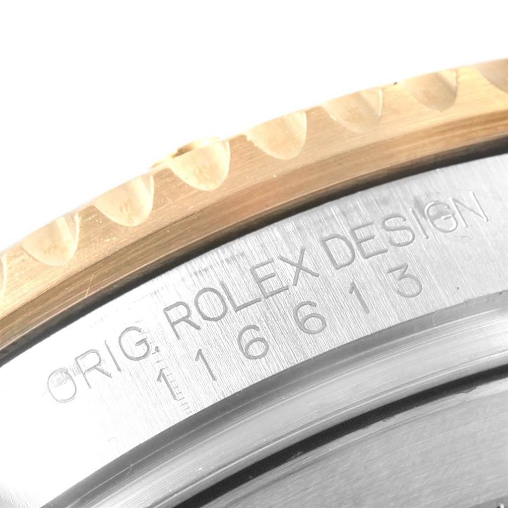 This image shows a close-up of the Rolex Submariner 116613 Men's Steel and Gold (two tone) Black Dial 116613 Men's Steel and Gold (two tone) Black Dial bezel and the engraved reference number on the case.