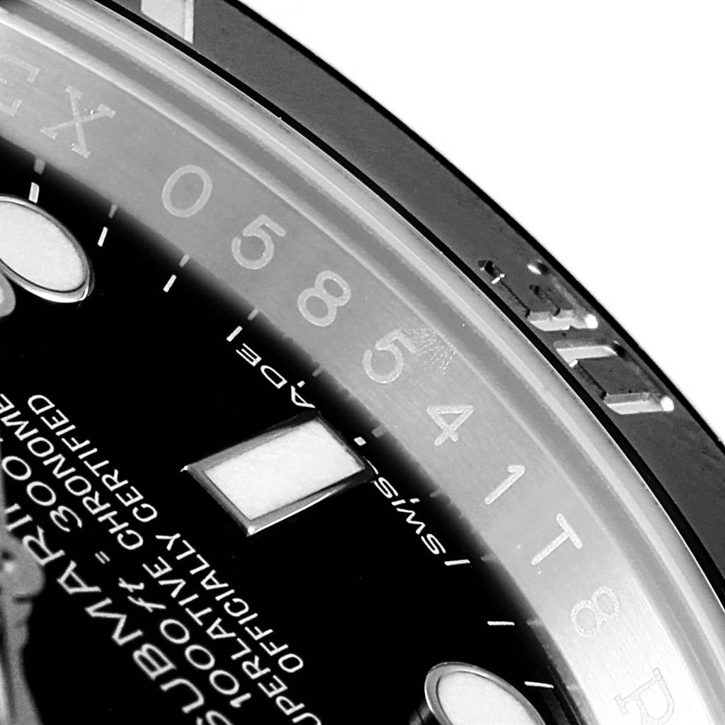 The image shows a close-up of the dial and bezel of a Rolex Submariner 114060 Men's Stainless Steel Black Dial 114060 Men's Stainless Steel Black Dial watch, emphasizing the markers and part of the model name.