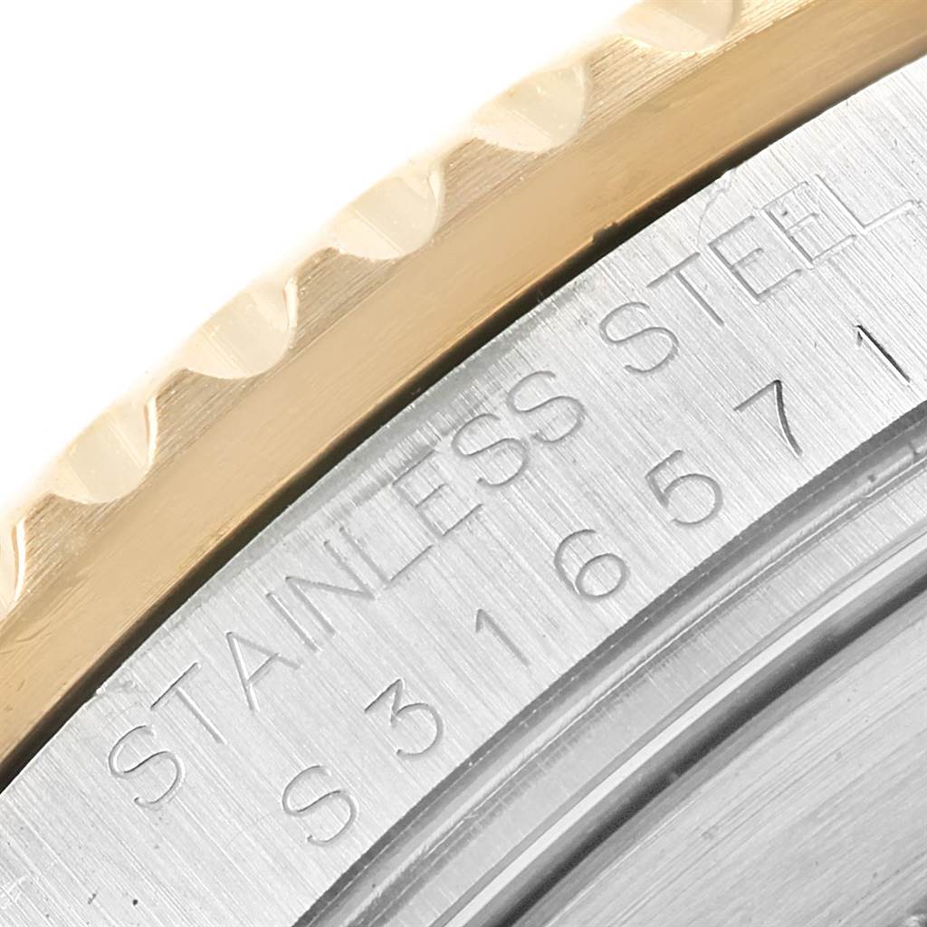 This image shows a close-up of the stainless steel case back and part of the bezel on a Rolex Submariner 16613 Men's Steel and Gold (two tone) Blue Dial 16613 Men's Steel and Gold (two tone) Blue Dial watch.