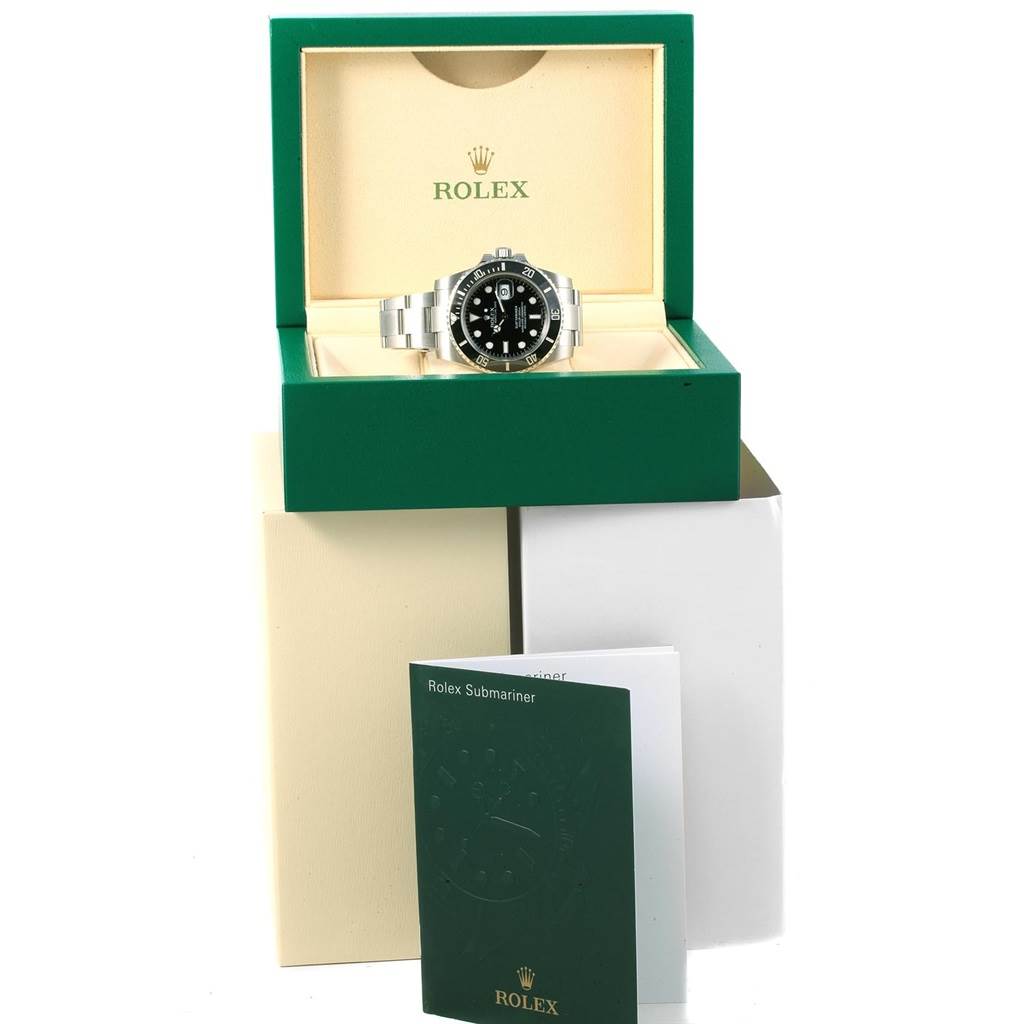 The Rolex Submariner 116610 Men
s Stainless Steel Black Dial 116610 Men
s Stainless Steel Black Dial is shown from a front angle, inside its green box, with accompanying paperwork in front.