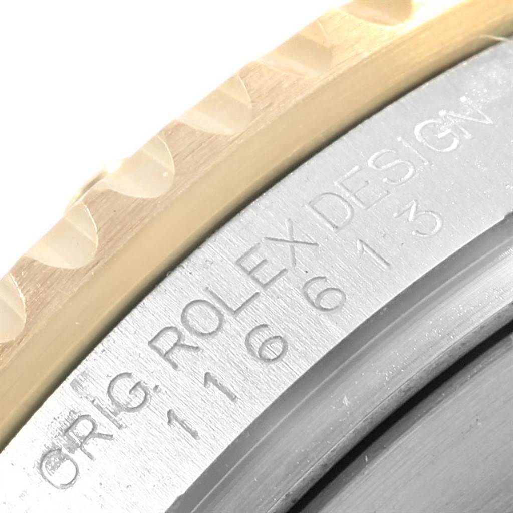 The image shows a close-up angle of the bezel and case of a Rolex Submariner 116613 Men's Steel and Gold (two tone) Blue Dial 116613 Men's Steel and Gold (two tone) Blue Dial watch, highlighting the model number and "ROLEX DESIGN" engraving.