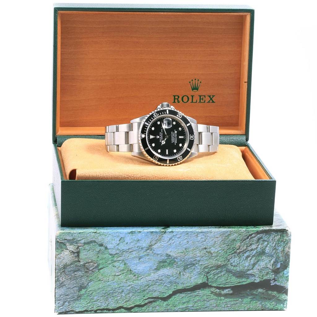 The Rolex Submariner 16610 Men
s Stainless Steel Black Dial 16610 Men
s Stainless Steel Black Dial watch is shown from the front, inside its open box, with a clear view of the dial and bracelet.