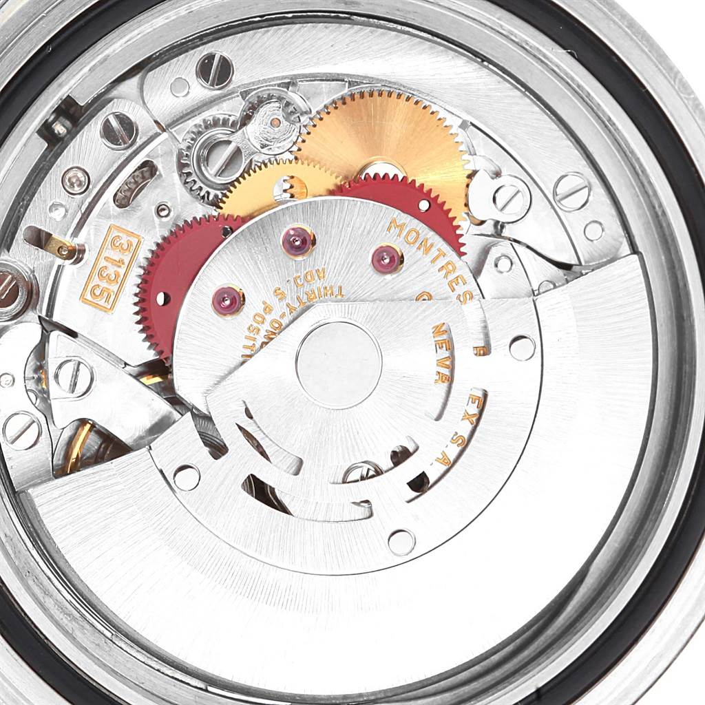 The image shows the internal mechanism and movement of a Rolex Submariner 16610 Men
s Stainless Steel Black Dial 16610 Men
s Stainless Steel Black Dial watch, including gears and the rotor.