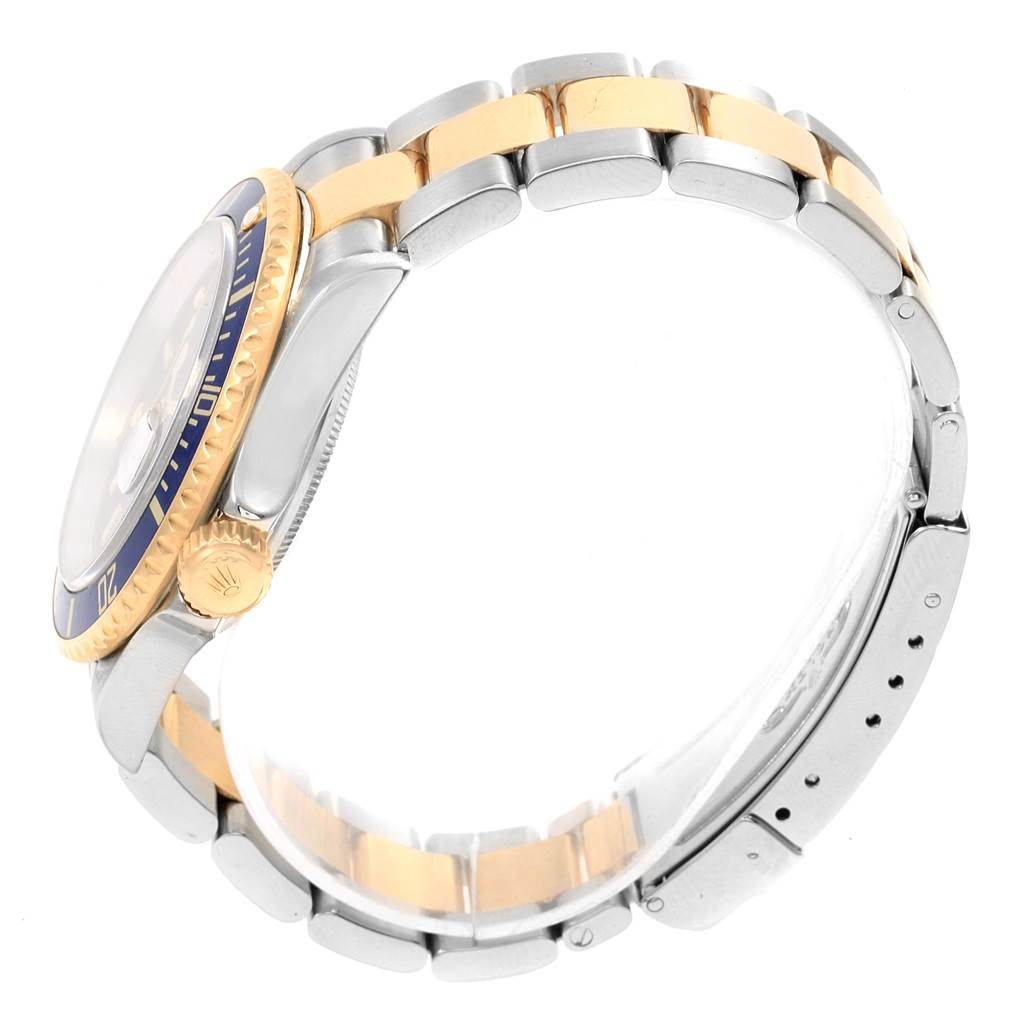 The image shows a side view of the Rolex Submariner 16613 Men
s Steel and Gold (two tone) Blue Dial 16613 Men
s Steel and Gold (two tone) Blue Dial watch, focusing on the band, bezel, and crown.
