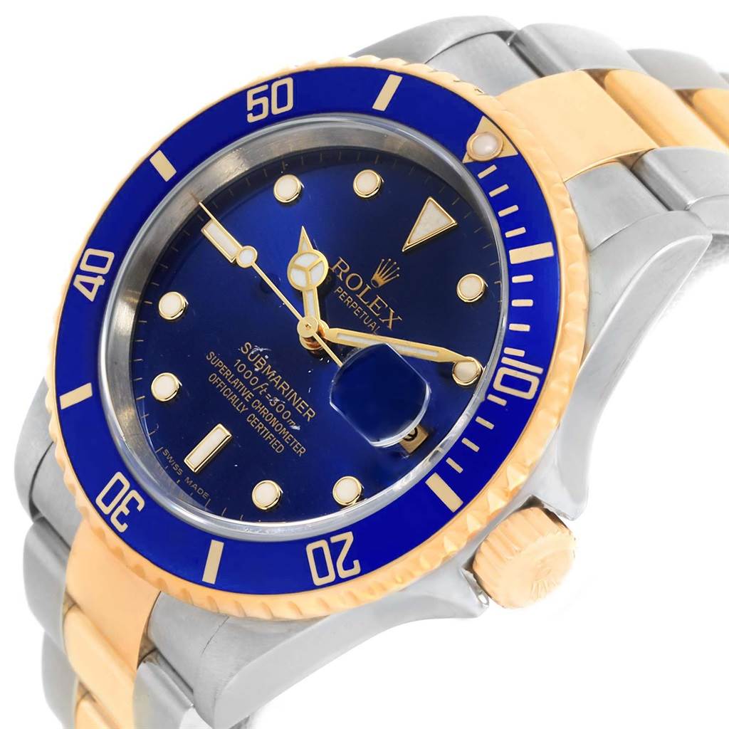The image shows a close-up, angled view of a Rolex Submariner 16613 Men
s Steel and Gold (two tone) Blue Dial 16613 Men
s Steel and Gold (two tone) Blue Dial, highlighting its blue dial and bezel, gold accents, and part of the bracelet.