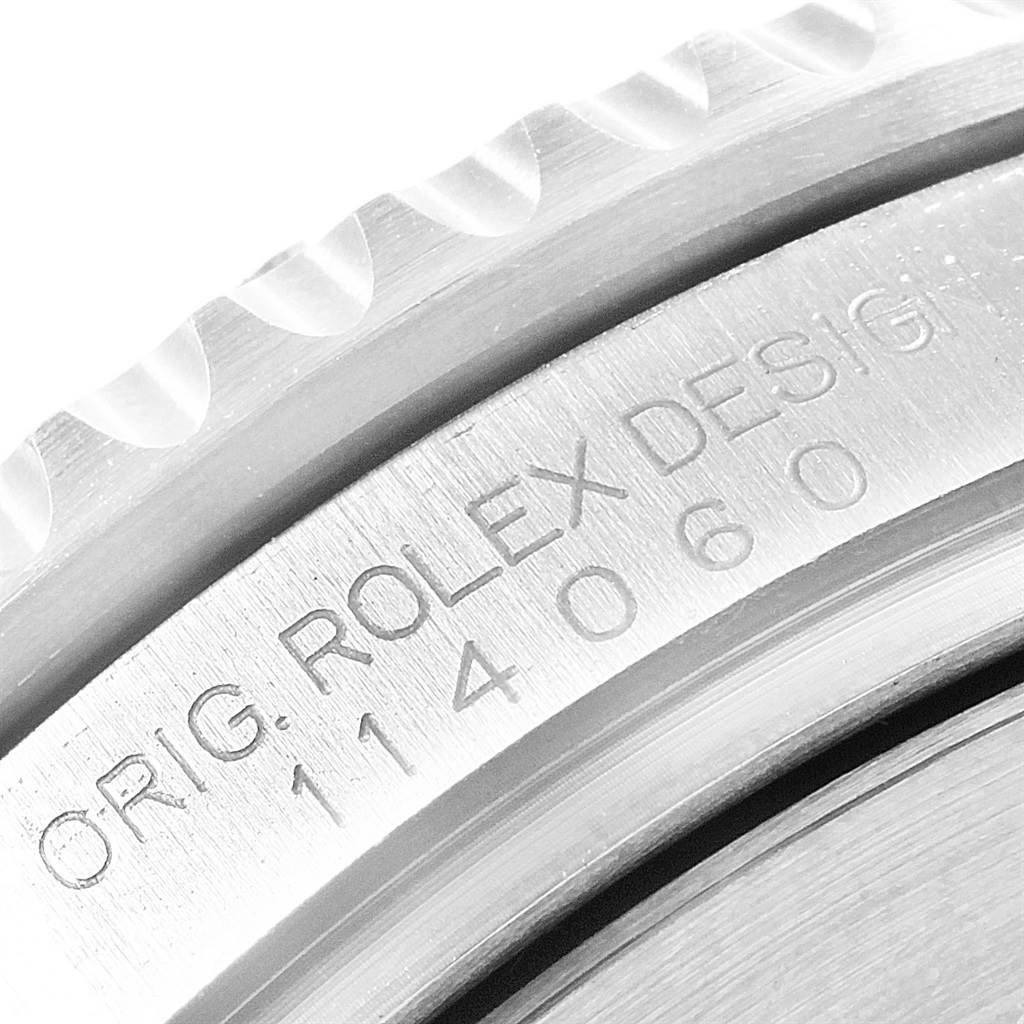 The image shows a close-up of the bezel and engraved case side of a Rolex Submariner 114060 Men
s Stainless Steel Black Dial 114060 Men
s Stainless Steel Black Dial watch.