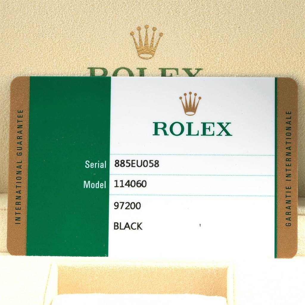 The image shows an international guarantee card with details for a Rolex Submariner 114060 Men
s Stainless Steel Black Dial 114060 Men
s Stainless Steel Black Dial model 114060.