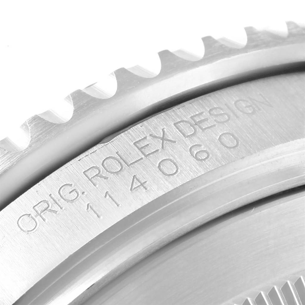 This image shows a close-up of the bezel and engraved serial number on a Rolex Submariner 114060 Men
s Stainless Steel Black Dial 114060 Men
s Stainless Steel Black Dial watch.