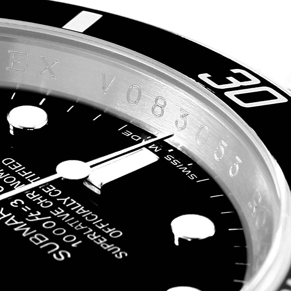 Close-up shot of an Best Quality
 Rolex Submariner 16610 Men
s Stainless Steel Black Dial 16610 Men
s Stainless Steel Black Dial model showing the dial, bezel, and part of the serial number.