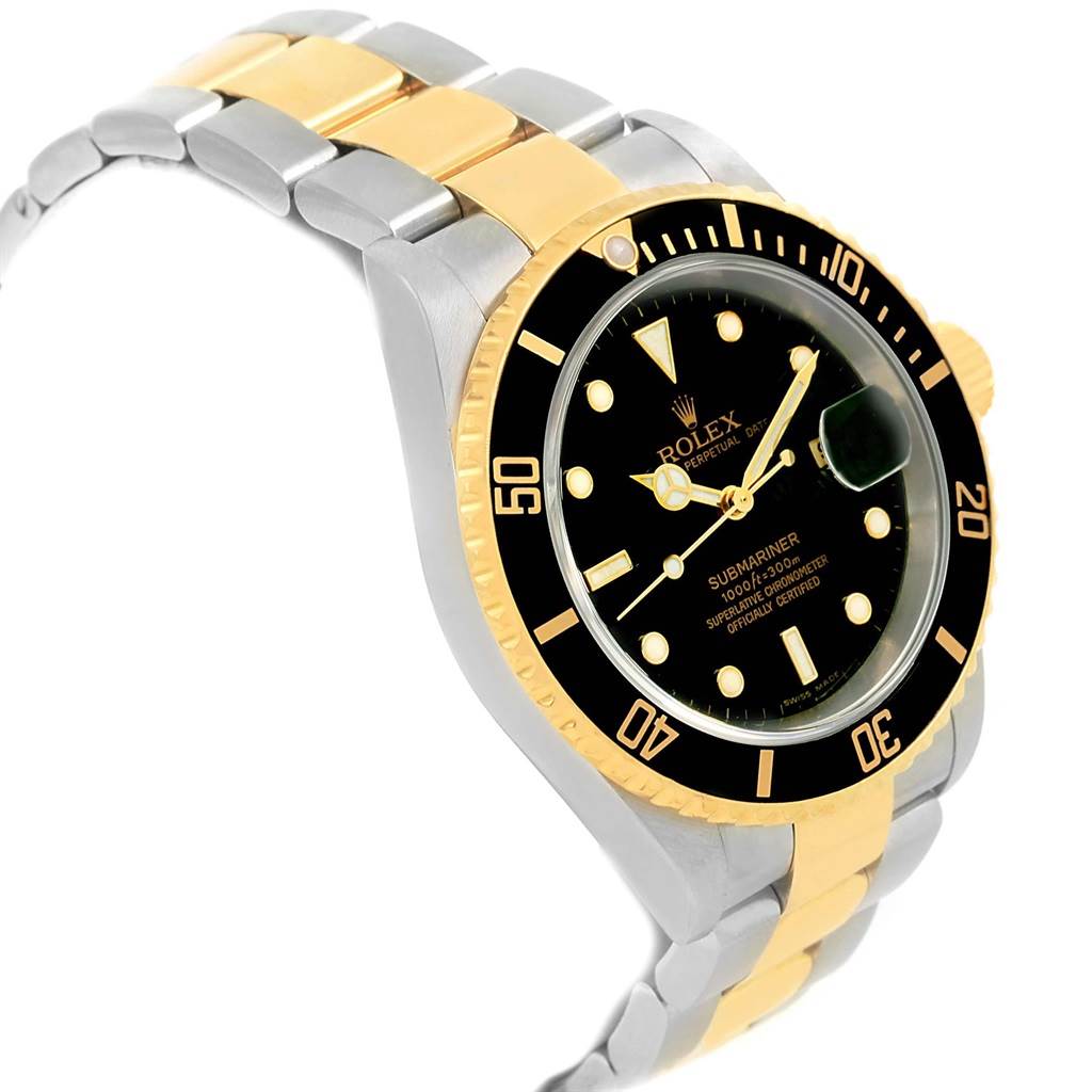 The Rolex Submariner 16613 Men's Steel and Gold (two tone) Black Dial 16613 Men's Steel and Gold (two tone) Black Dial watch is shown at a slight angle, highlighting its black dial, two-tone bracelet, and unidirectional bezel.
