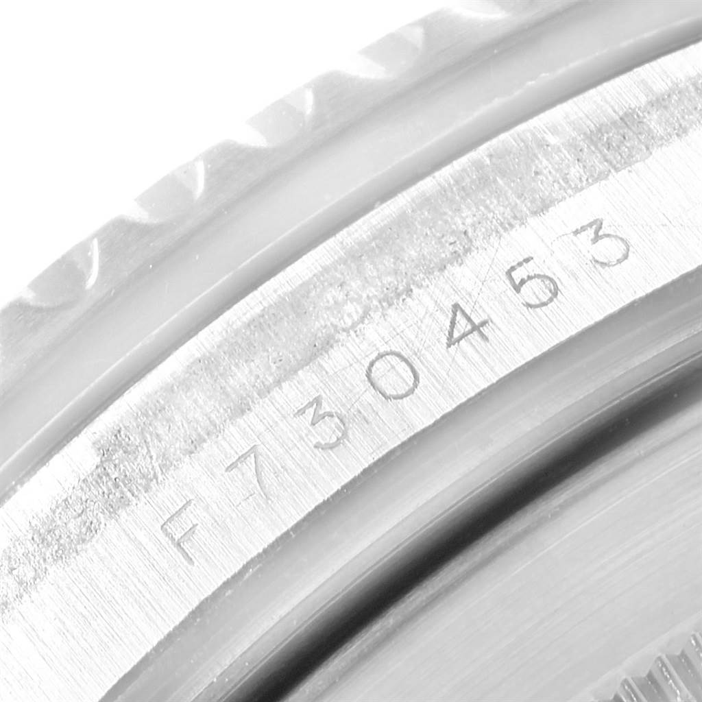 The image shows a close-up of the serial number and the casing edge of a Rolex Submariner 16610LV Men
s Stainless Steel Black Dial 16610LV Men
s Stainless Steel Black Dial watch.