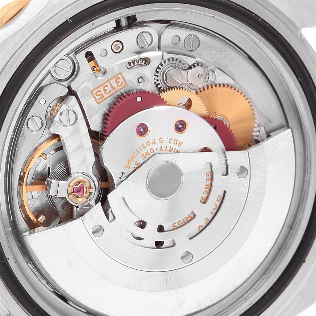 The image shows an up-close view of the Rolex Submariner 16613 Men
s Steel and Gold (two tone) Grey Dial 16613 Men
s Steel and Gold (two tone) Grey Dial
s intricate internal movement and gears.