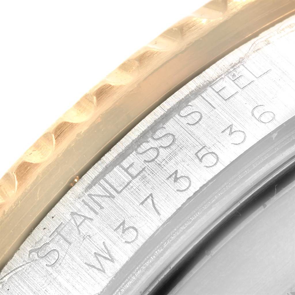 The image shows a close-up of the case side and serial number engraving on a Rolex Submariner 16613 Men
s Steel and Gold (two tone) Grey Dial 16613 Men
s Steel and Gold (two tone) Grey Dial watch.