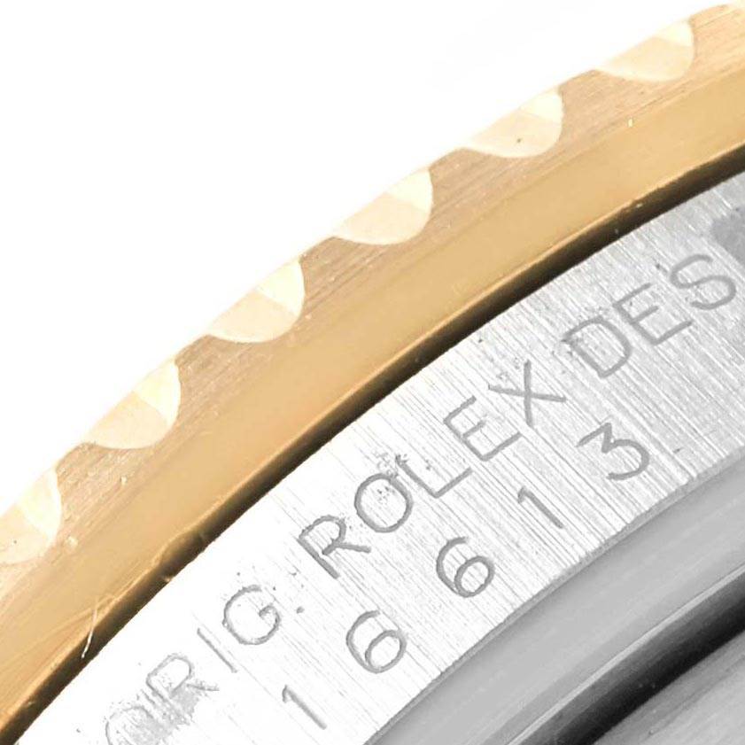 The image shows a close-up of the bezel and part of the engraved inner ring of a Rolex Submariner 16613 Men
s Steel and Gold (two tone) Grey Dial 16613 Men
s Steel and Gold (two tone) Grey Dial watch.