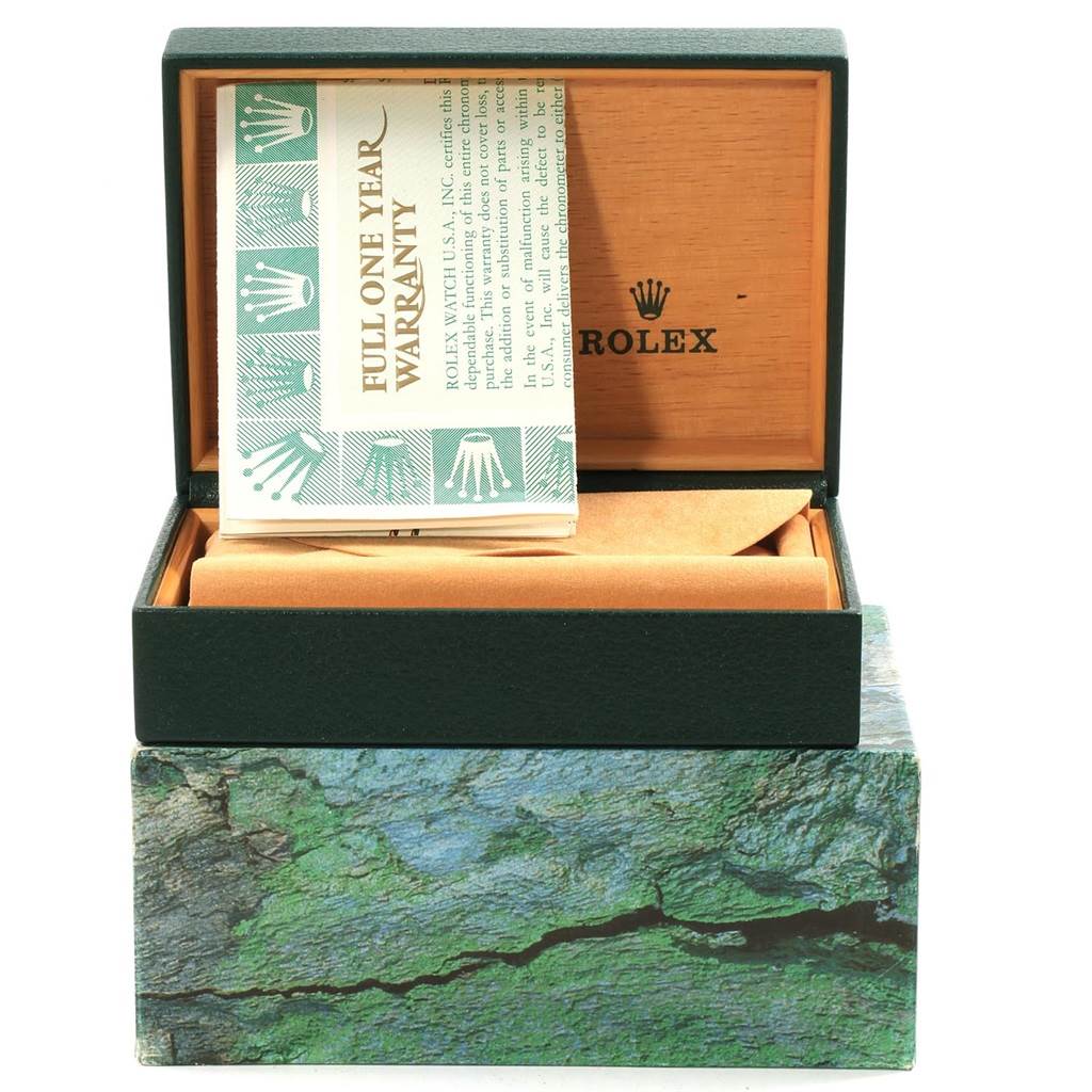 The image shows a Rolex Submariner 16613 Men
s Steel and Gold (two tone) Grey Dial 16613 Men
s Steel and Gold (two tone) Grey Dial watch box and its warranty card, with the box opened at a front angle.