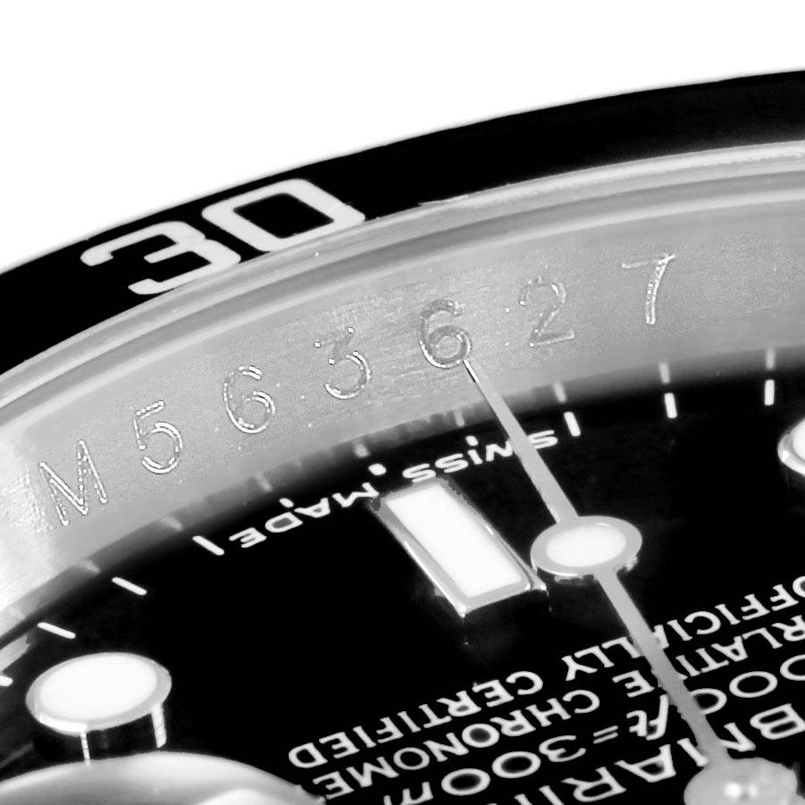The close-up image shows the serial number and part of the bezel and dial of the Rolex Submariner 16610 Men
s Stainless Steel Black Dial 16610 Men
s Stainless Steel Black Dial watch.