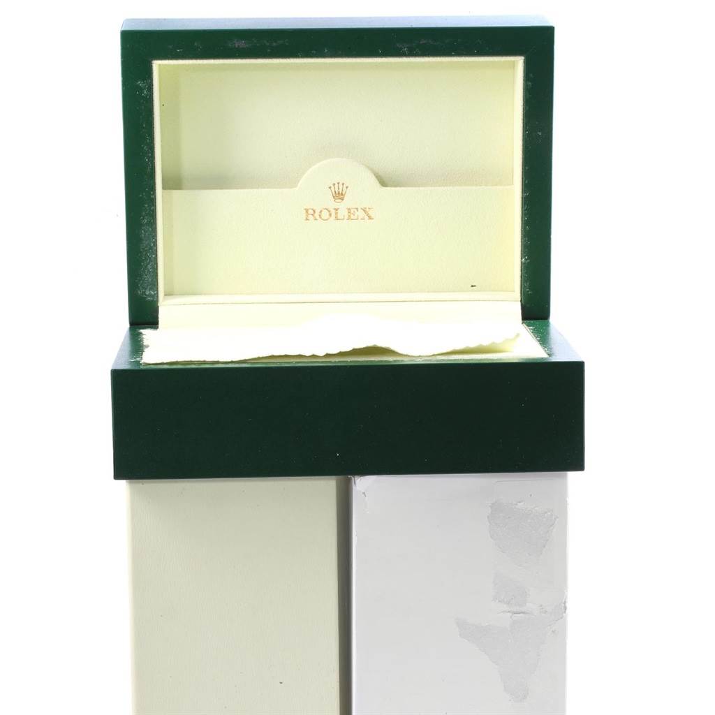 The image shows an open green and beige Rolex box designed to hold a Submariner model watch.