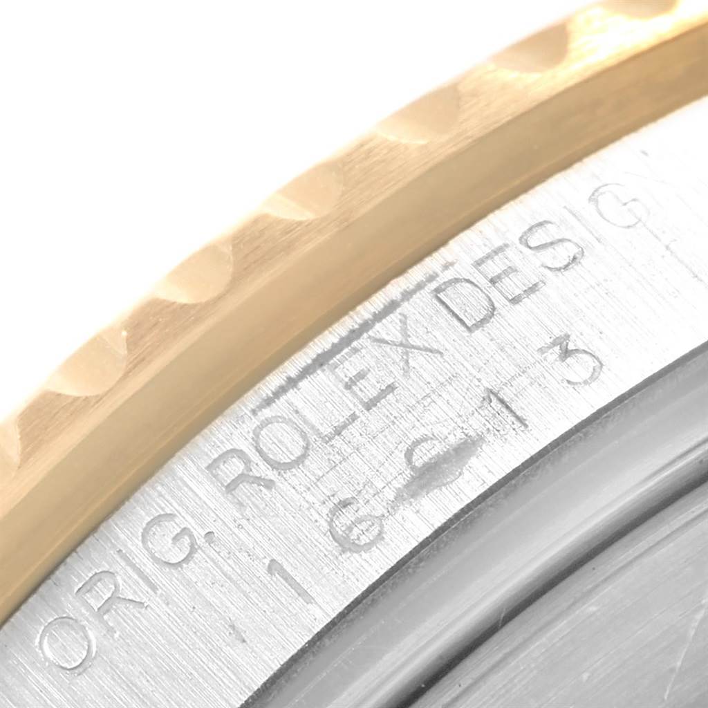 This image shows the side view of the case and bezel of a Rolex Submariner 16613 Men's Steel and Gold (two tone) Blue Dial 16613 Men's Steel and Gold (two tone) Blue Dial with the model details engraved.