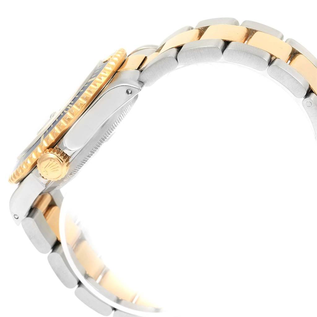 This side-angle view of the Rolex Submariner 16613 Men's Steel and Gold (two tone) Blue Dial 16613 Men's Steel and Gold (two tone) Blue Dial shows its crown, side case, and two-tone bracelet.