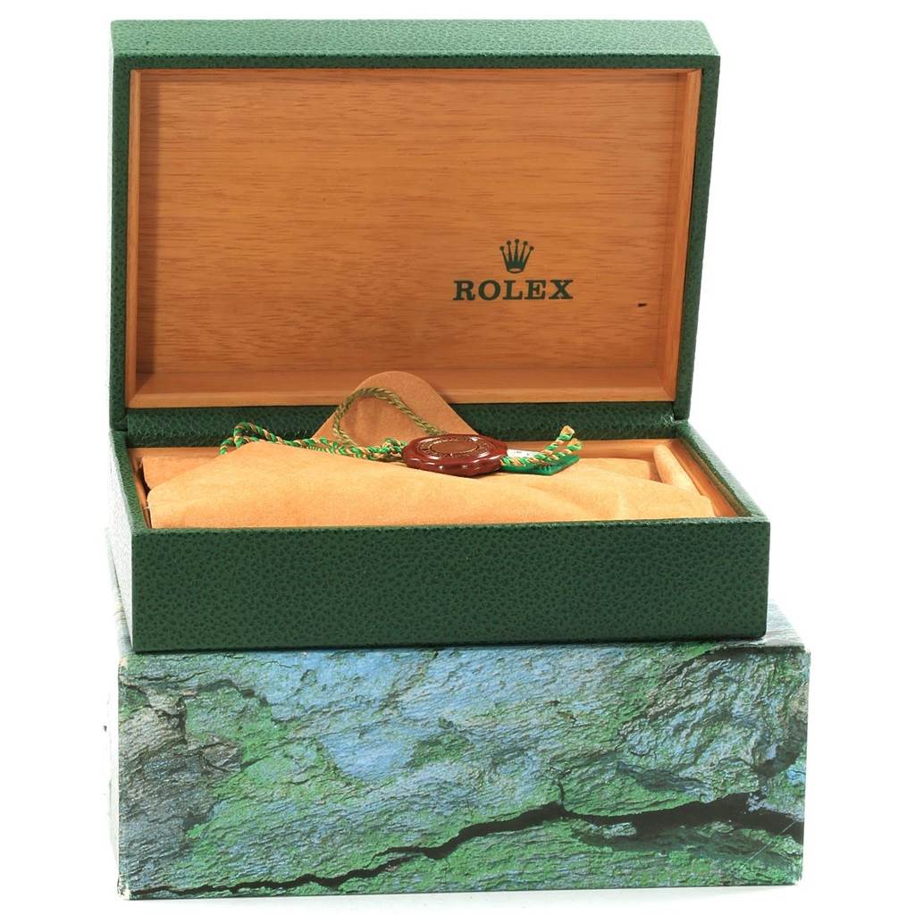 The image shows an open box of a Rolex Submariner 16610 Men
s Stainless Steel Black Dial 16610 Men
s Stainless Steel Black Dial watch, displaying its packaging and a tag inside the box.