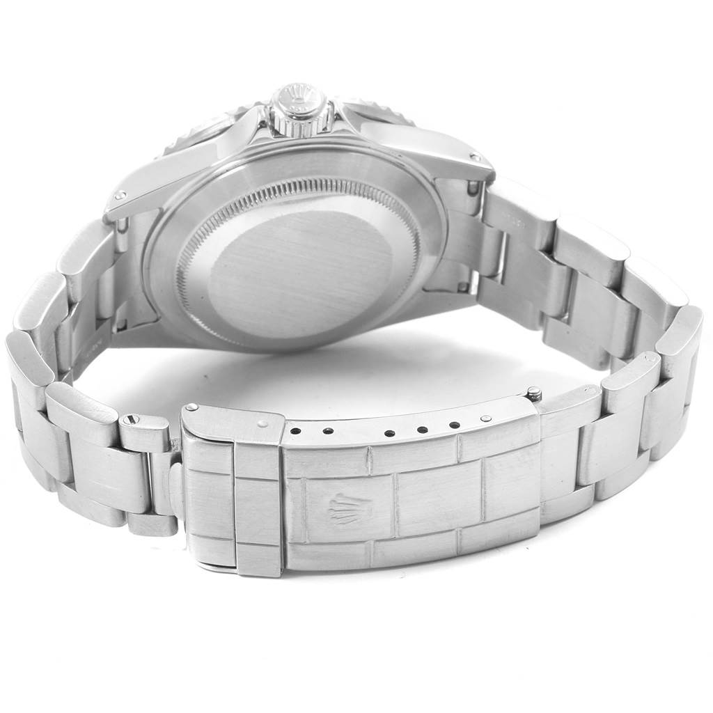 The image shows the back view of a Rolex Submariner 16610 Men
s Stainless Steel Black Dial 16610 Men
s Stainless Steel Black Dial, highlighting the case back and part of the stainless steel bracelet.