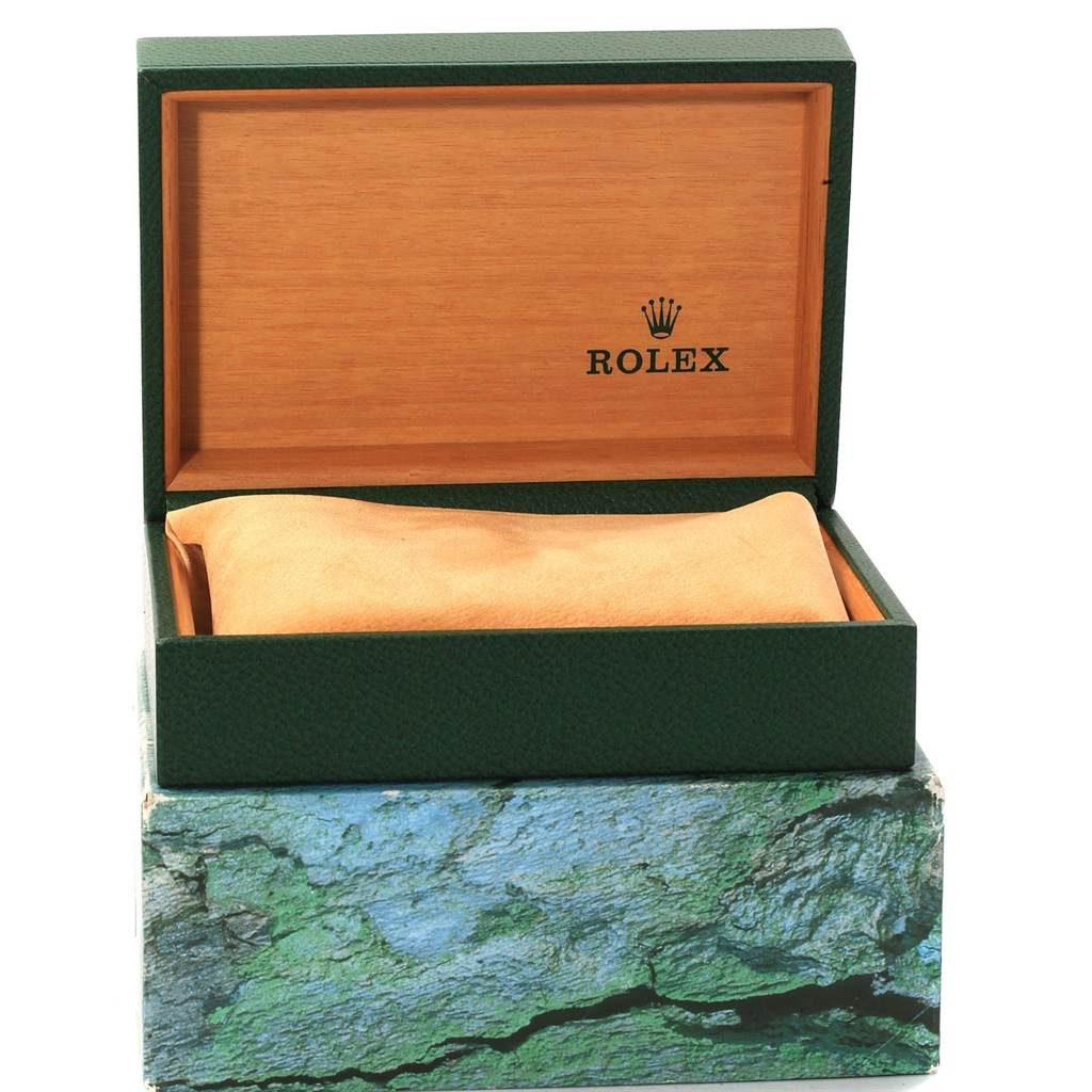 The image shows an open Rolex Submariner 16610 Men
s Stainless Steel Black Dial 16610 Men
s Stainless Steel Black Dial watch box, revealing the inner cushion and brand logo inside the lid.