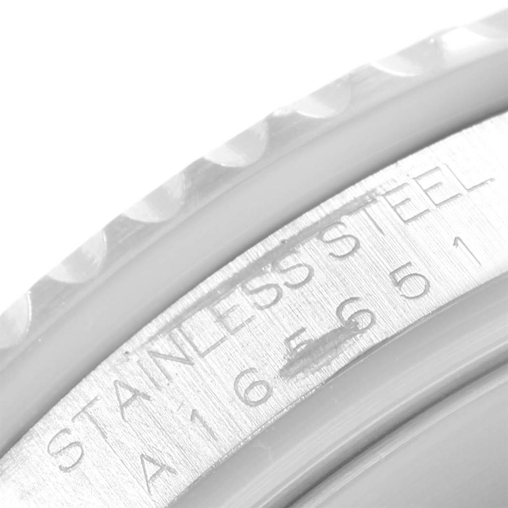 The image shows a close-up of the case
s side detailing and serial number of a Rolex Submariner 16610 Men
s Stainless Steel Black Dial 16610 Men
s Stainless Steel Black Dial watch.