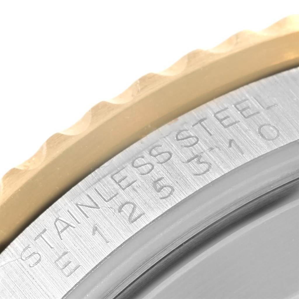 This close-up image showcases the engraved edge and stainless steel bezel of the Rolex Submariner 16613 Men's Steel and Gold (two tone) Blue Dial 16613 Men's Steel and Gold (two tone) Blue Dial watch.