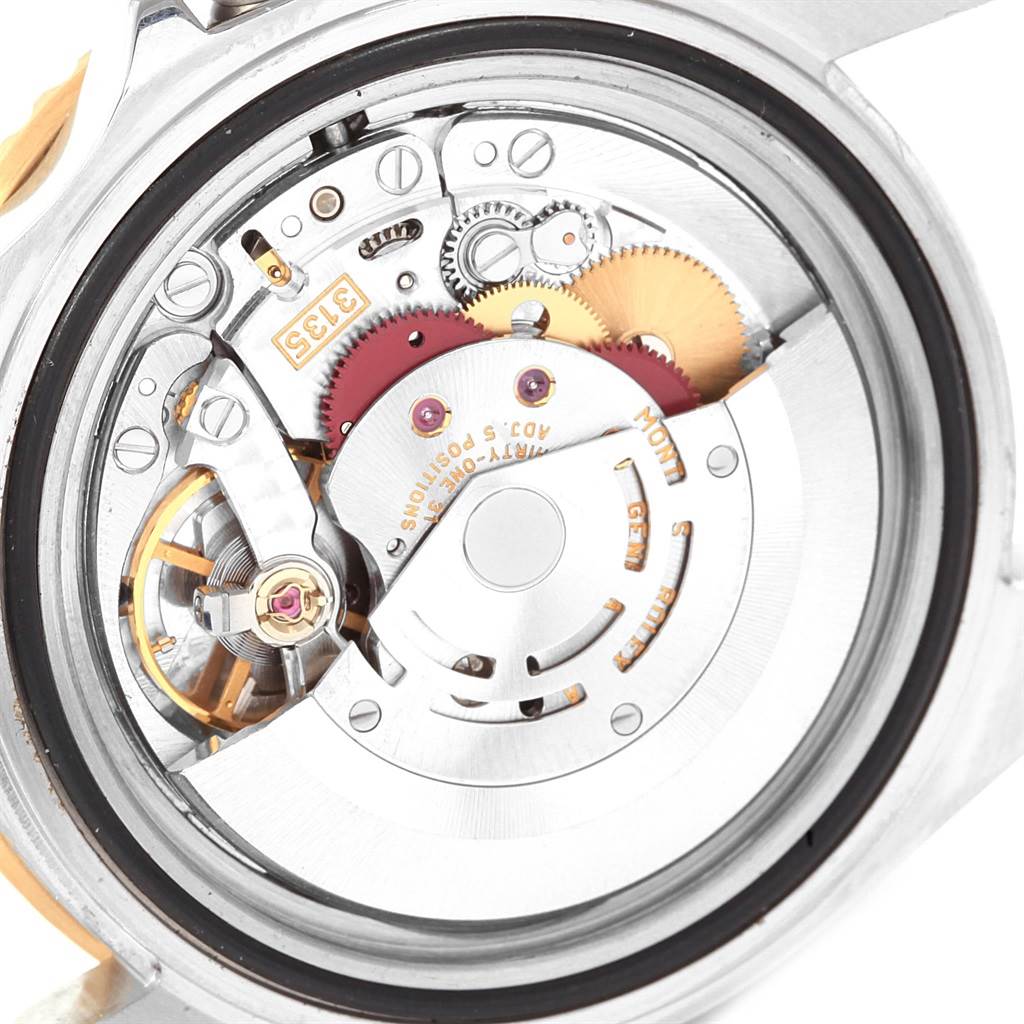 The image shows a close-up view of the internal mechanical movement of a Rolex Submariner 16613 Men's Steel and Gold (two tone) Blue Dial 16613 Men's Steel and Gold (two tone) Blue Dial watch.