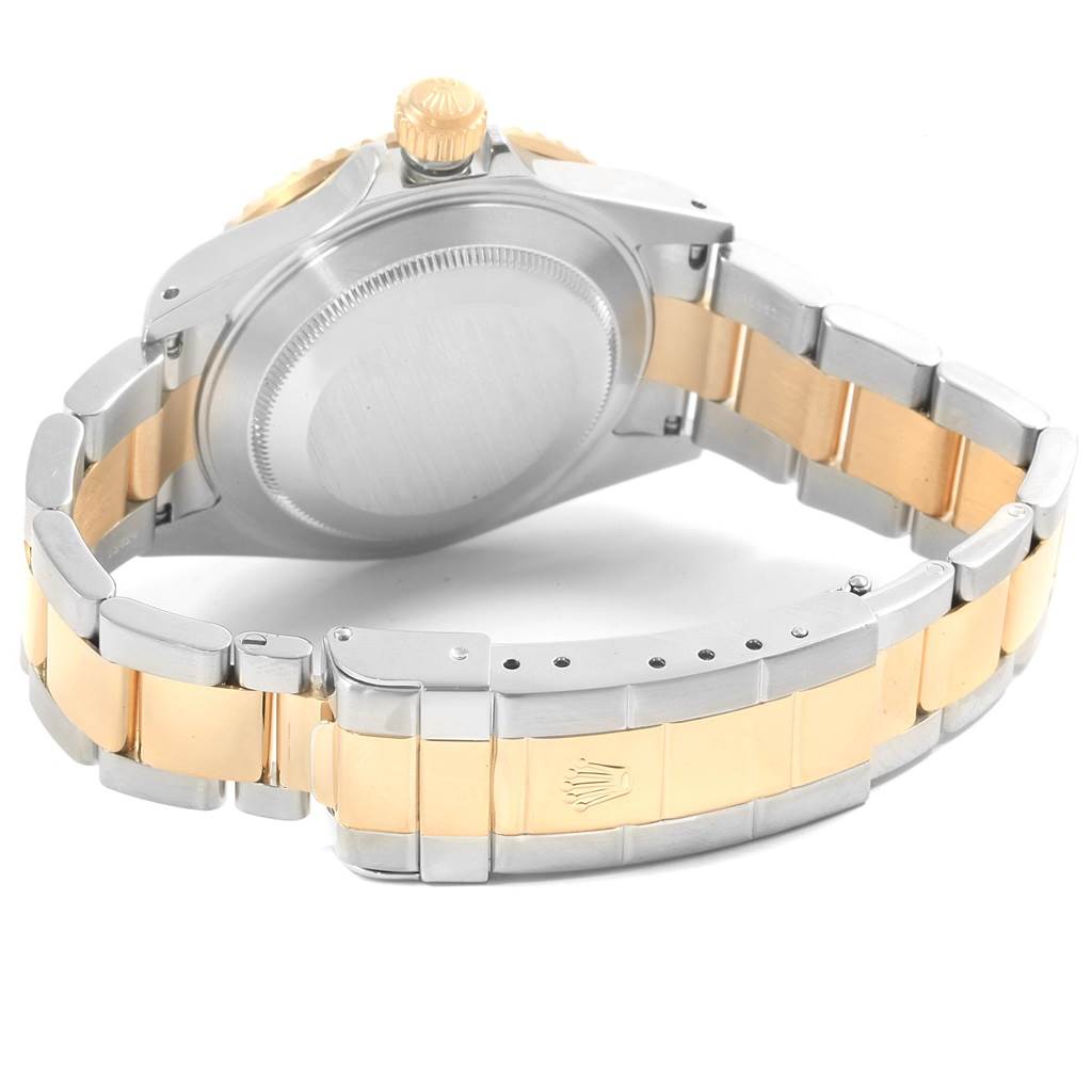 The image shows the back case and bracelet of a Rolex Submariner 16613 Men's Steel and Gold (two tone) Blue Dial 16613 Men's Steel and Gold (two tone) Blue Dial watch at an angled view.