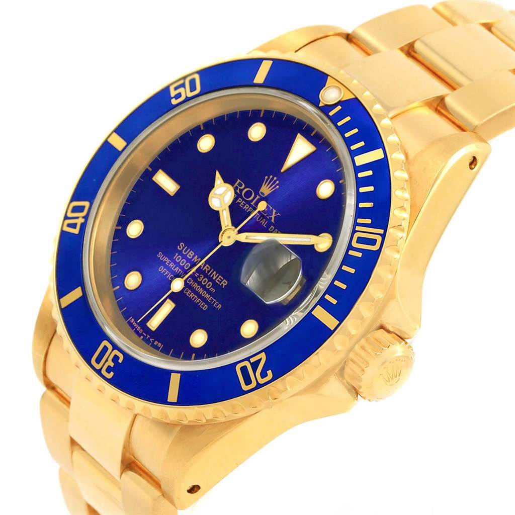 The image shows a Rolex Submariner 16618 Men's Yellow Gold Purple Dial 16618 Men's Yellow Gold Purple Dial watch at an angle, highlighting its blue bezel, dial, and gold bracelet.