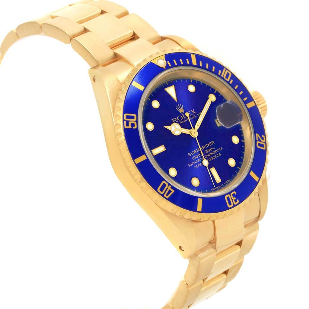 This image shows a side angle of a Rolex Submariner 16618 Men's Yellow Gold Purple Dial 16618 Men's Yellow Gold Purple Dial watch, showcasing its blue dial, bezel, and gold bracelet.