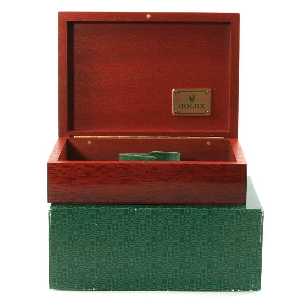 This image shows an open wooden box for the Rolex Submariner 16618 Men's Yellow Gold Purple Dial 16618 Men's Yellow Gold Purple Dial watch, placed on a green patterned box.
