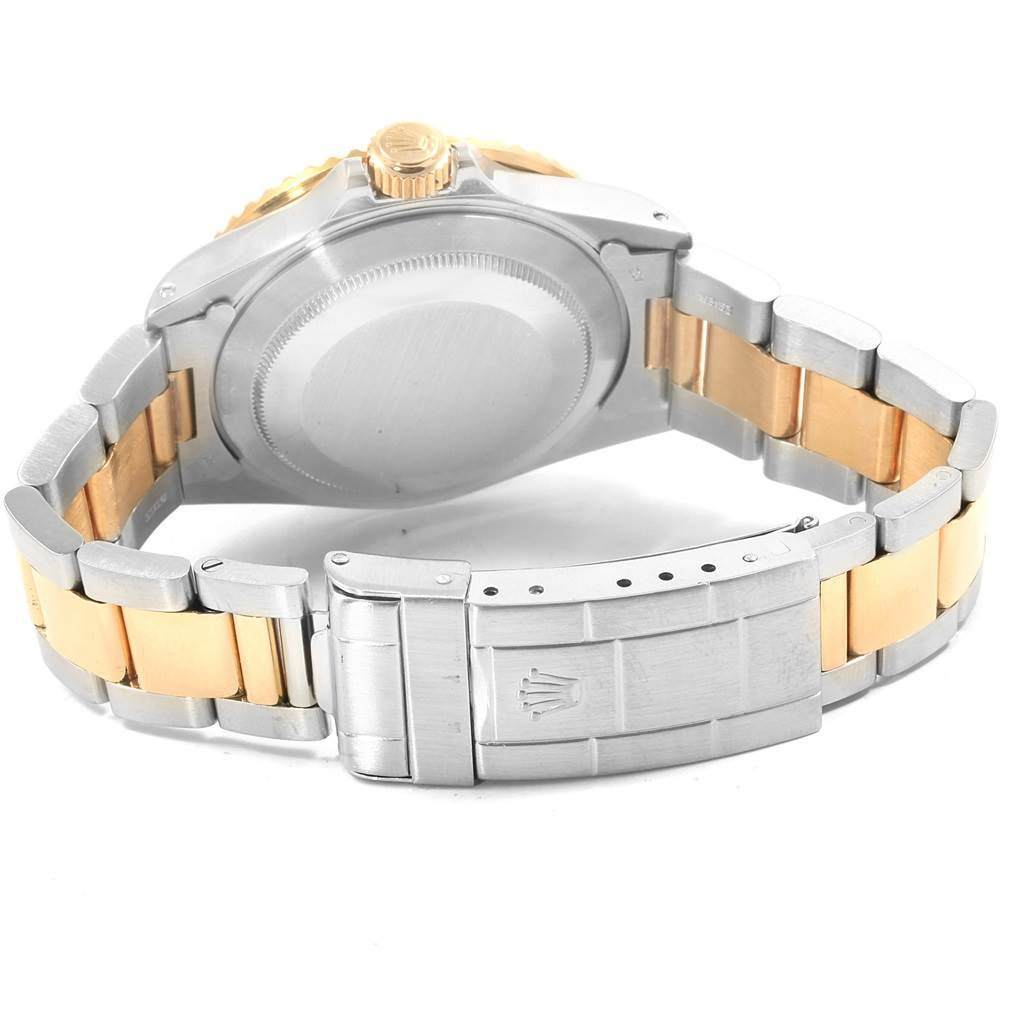 This image shows the underside of a Rolex Submariner 16803 Men's Steel and Gold (two tone) Blue Dial 16803 Men's Steel and Gold (two tone) Blue Dial watch, highlighting the case back, bracelet, and clasp.