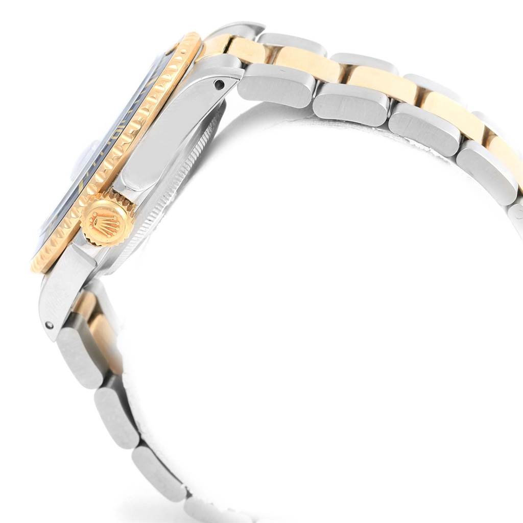 This image shows a side view of a Rolex Submariner 16803 Men's Steel and Gold (two tone) Blue Dial 16803 Men's Steel and Gold (two tone) Blue Dial's case, bezel, crown, and part of the two-tone bracelet.