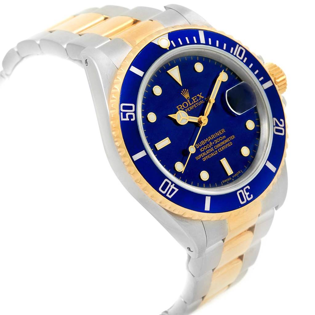 The image shows a Rolex Submariner 16803 Men's Steel and Gold (two tone) Blue Dial 16803 Men's Steel and Gold (two tone) Blue Dial watch at a slight angle, highlighting its blue dial and bezel, gold and silver bracelet, and magnified date window.