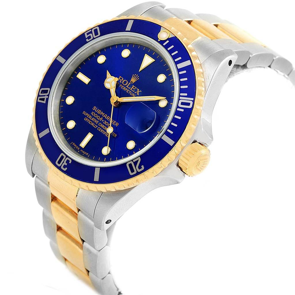 The Rolex Submariner 16803 Men's Steel and Gold (two tone) Blue Dial 16803 Men's Steel and Gold (two tone) Blue Dial is displayed at a slight angle, showing its blue dial, gold bezel, and two-tone bracelet.
