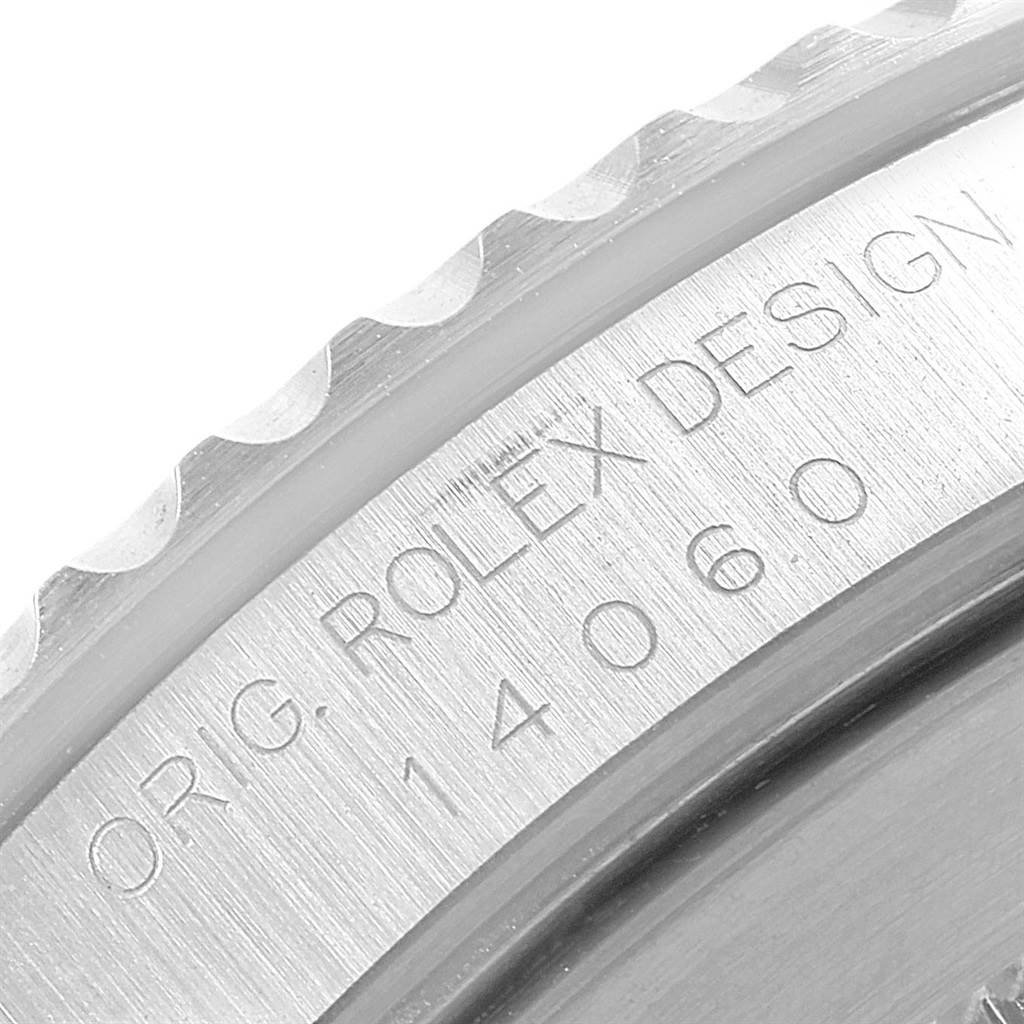 The image shows a close-up of the case back edge of a Rolex Submariner 14060 Men
s Stainless Steel Black Dial 14060 Men
s Stainless Steel Black Dial watch with the inscription "ORIG. ROLEX DESIGN 14060".