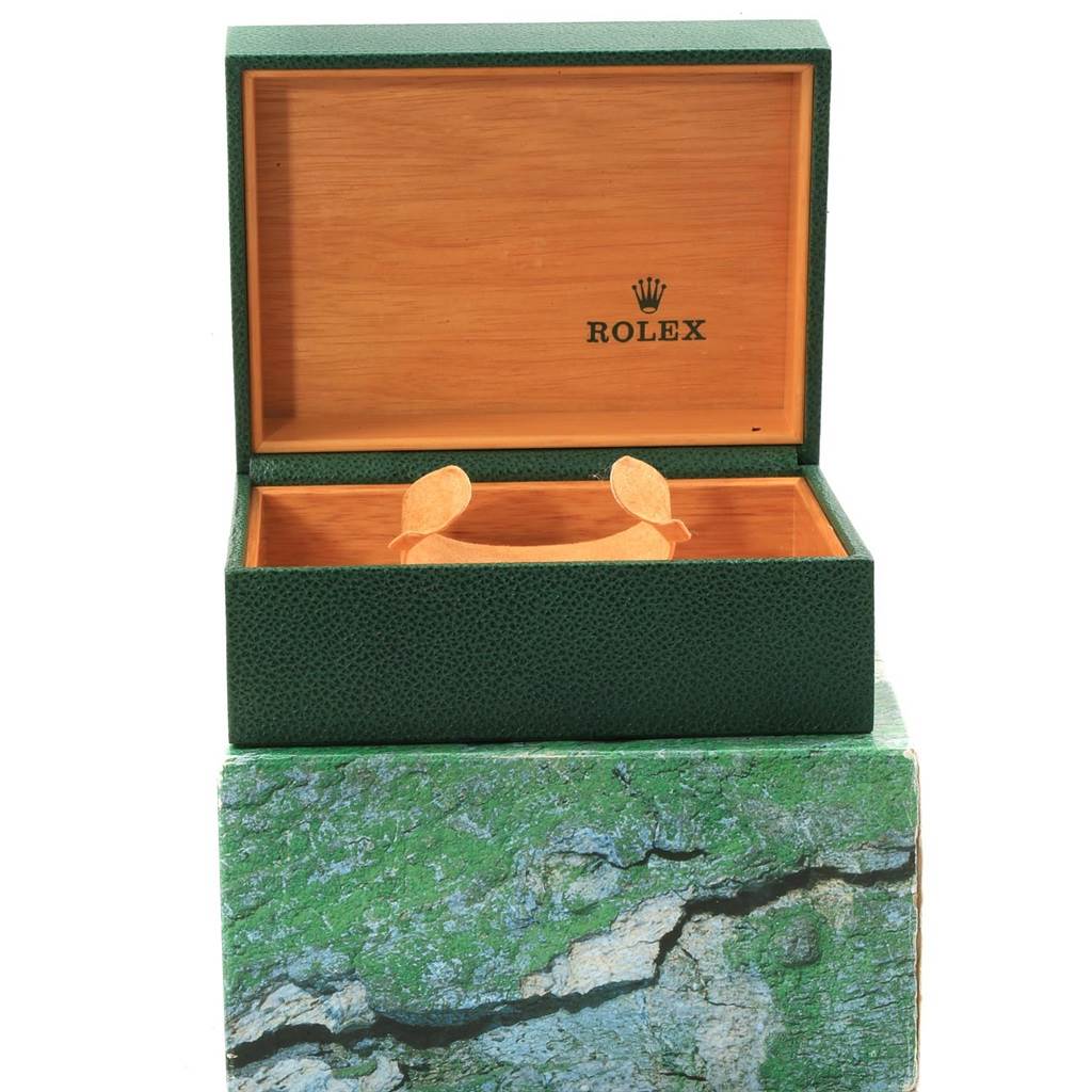 The image shows an open green Rolex box on a green outer packaging, but no Rolex Submariner 14060 Men
s Stainless Steel Black Dial 14060 Men
s Stainless Steel Black Dial watch is visible.