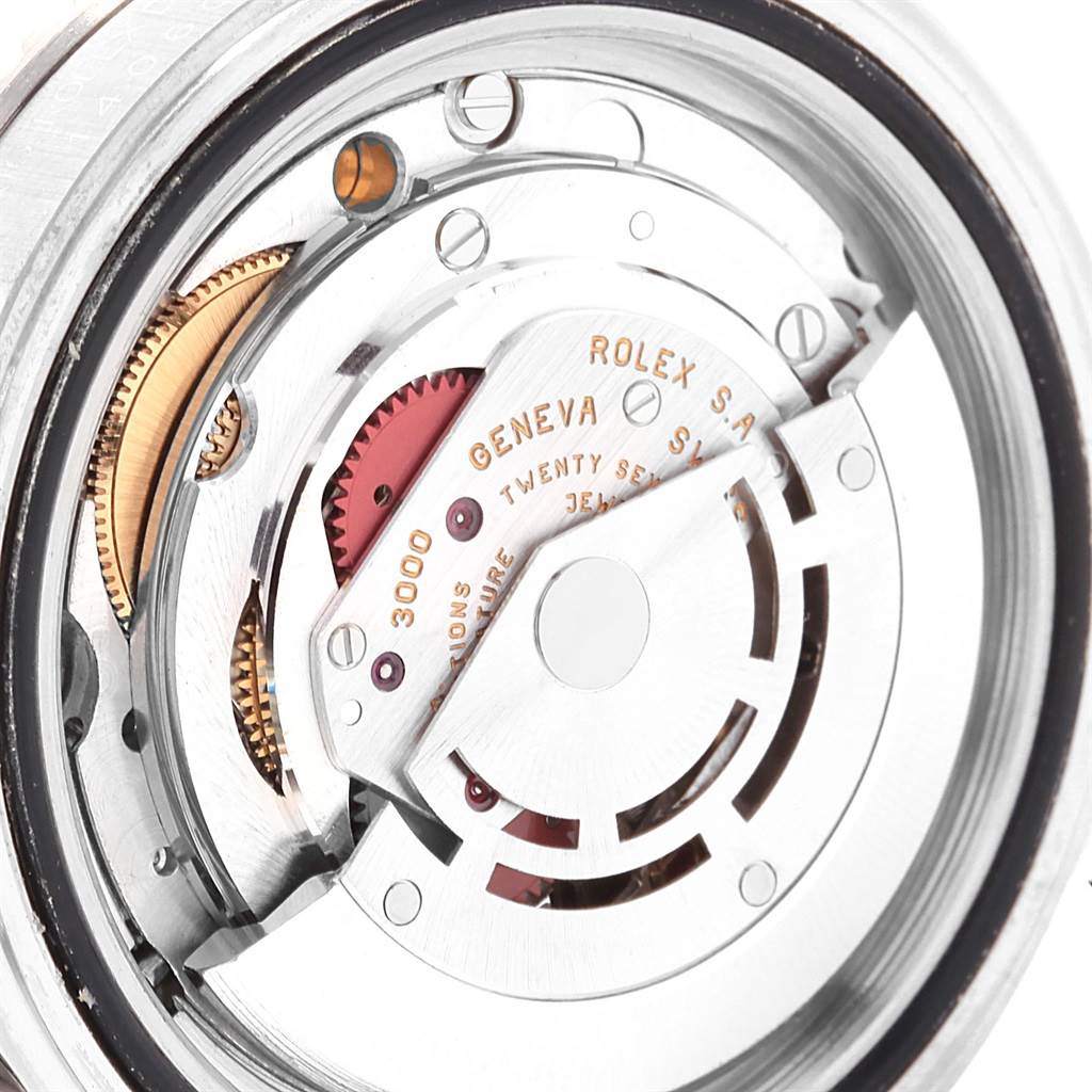 The image shows the intricate internal mechanism of the Rolex Submariner 14060 Men
s Stainless Steel Black Dial 14060 Men
s Stainless Steel Black Dial watch from a rear angle, highlighting its gears and movement parts.