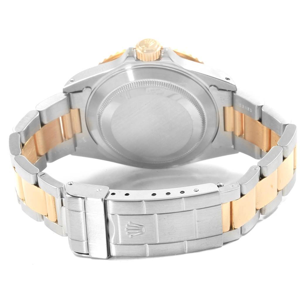 The image shows the back case and bracelet of a Rolex Submariner 16613 Men's Steel and Gold (two tone) Black Dial 16613 Men's Steel and Gold (two tone) Black Dial watch, highlighting the clasp and crown.