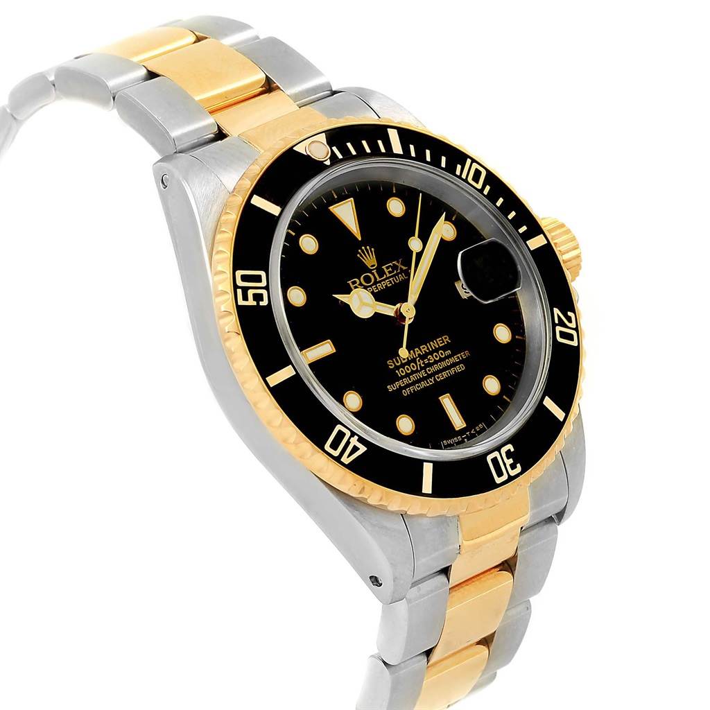 This Rolex Submariner 16613 Men's Steel and Gold (two tone) Black Dial 16613 Men's Steel and Gold (two tone) Black Dial watch is shown at an angle displaying the dial, bezel, and part of the two-tone bracelet.