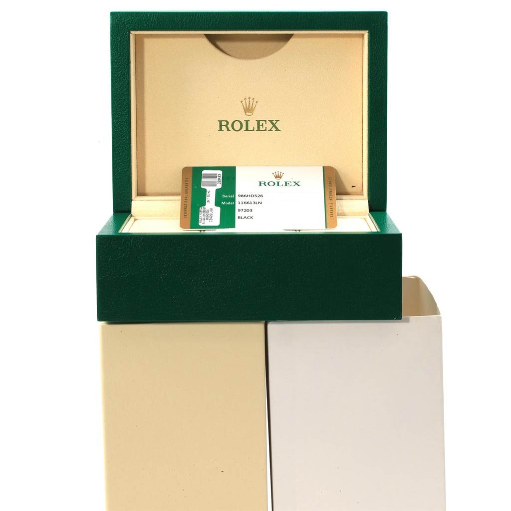 The image shows a green Rolex box for the Submariner model, with an open lid revealing the watch's certification card.