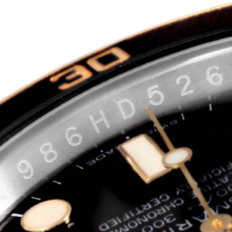 The image shows a close-up top angle of the bezel and face of a Rolex Submariner 116613 Men's Steel and Gold (two tone) Black Dial 116613 Men's Steel and Gold (two tone) Black Dial watch, highlighting the numbers and markers.
