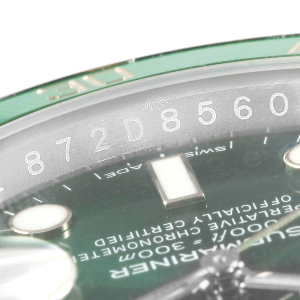 This is a close-up of the Rolex Submariner 16610LV Men's Stainless Steel Green Dial 16610LV Men's Stainless Steel Green Dial's serial number, bezel, and part of the dial.